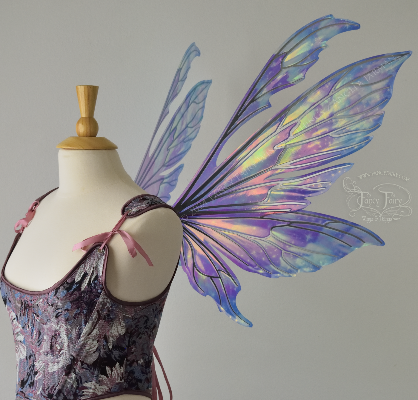 Iridescent fairy wings with pointed tips & antennae, painted with auroras & stars in pinks, purples & blues, with silver veins, right side view