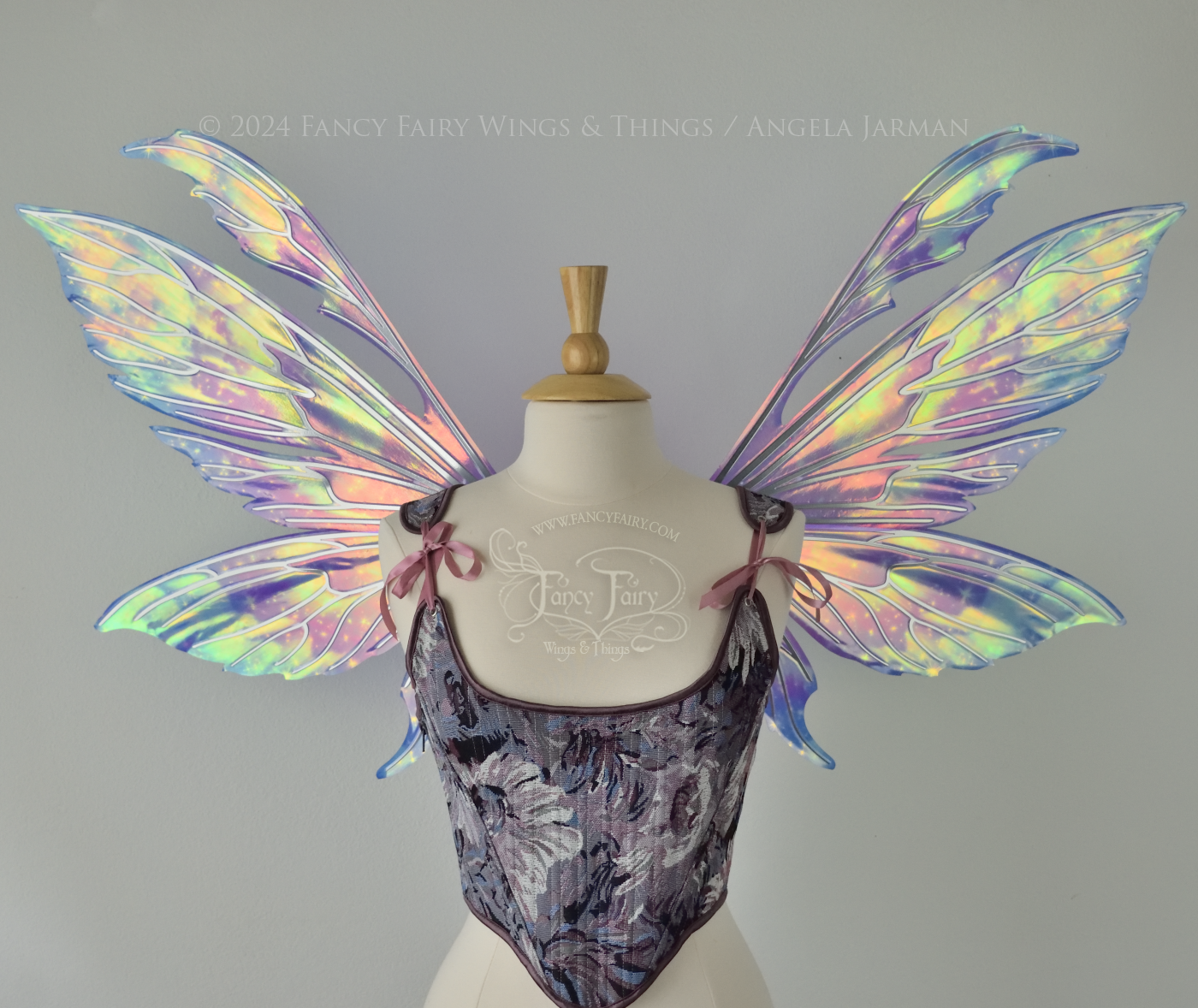 Iridescent fairy wings with pointed tips & antennae, painted with auroras & stars in pinks, purples & blues, with silver veins, front view