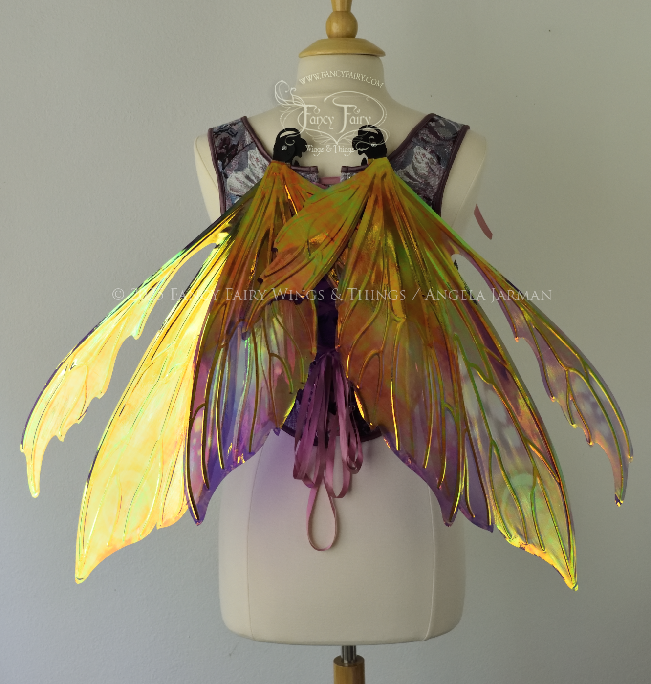 Purple & magenta iridescent fairy wings with antennae, black veins, worn on a dress form, back view, in resting position