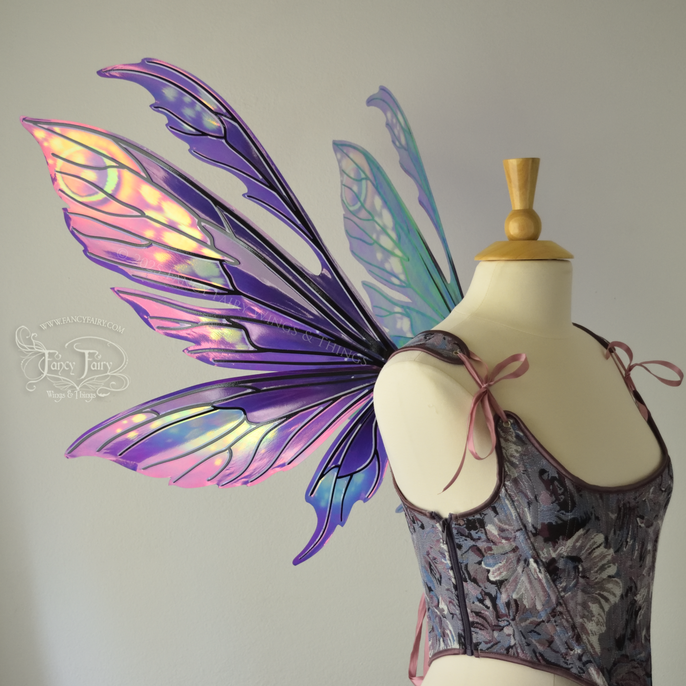 Purple & magenta iridescent fairy wings with antennae, black veins, worn on a dress form, left side view