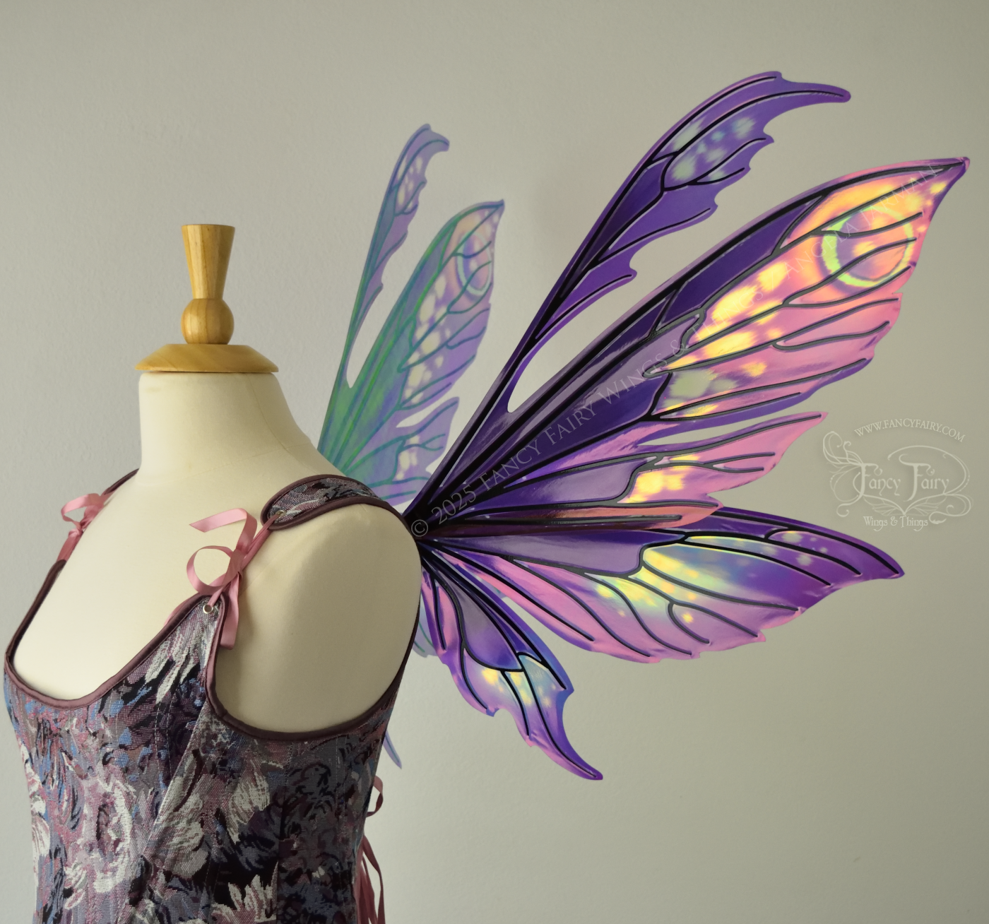 Purple & magenta iridescent fairy wings with antennae, black veins, worn on a dress form, right side view