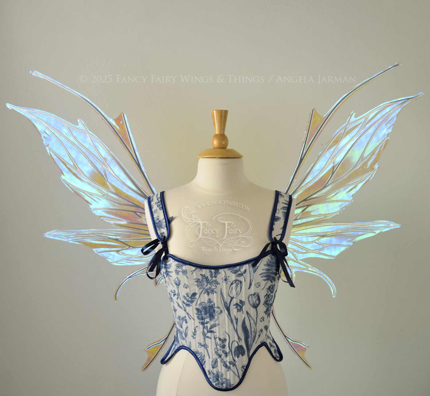 Large blue / green iridescent fairy wings with silver veins featuring antennae along the top and a spikey profile, worn on a dress form, front view