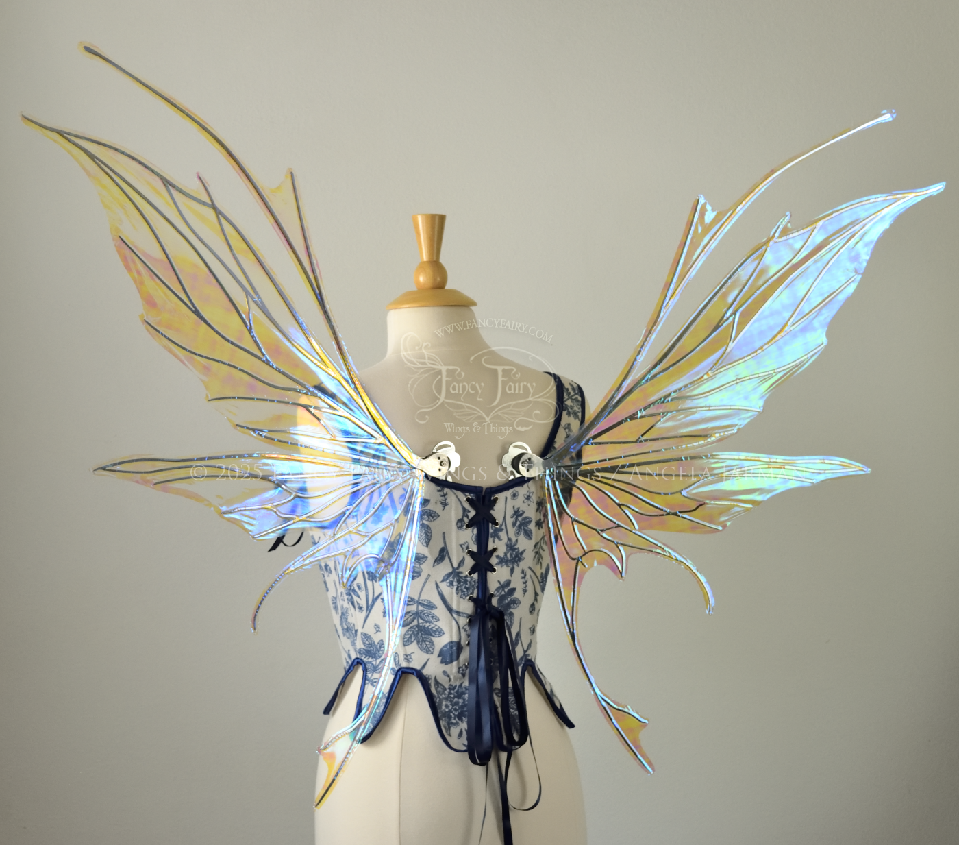 Large blue / green iridescent fairy wings with silver veins featuring antennae along the top and a spikey profile, worn on a dress form, back view