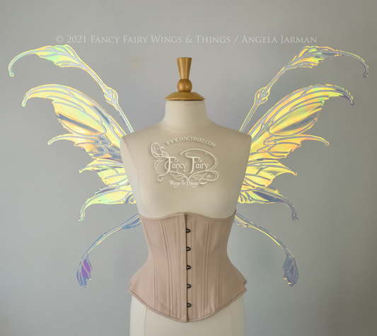 Front view of a dress form wearing an underbust corset & 'Fauna' transparent iridescent fairy wings with downward curved tips, antennae & wispy 'tails', with white veining
