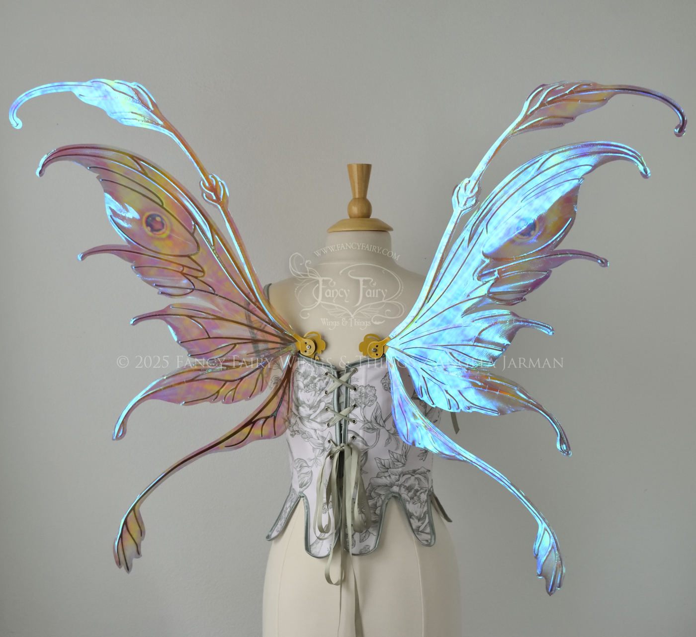 Iridescent pastel rainbow fairy wings with downward curved tips, antennae and appendages, with gold veins, worn on a dress form, back view
