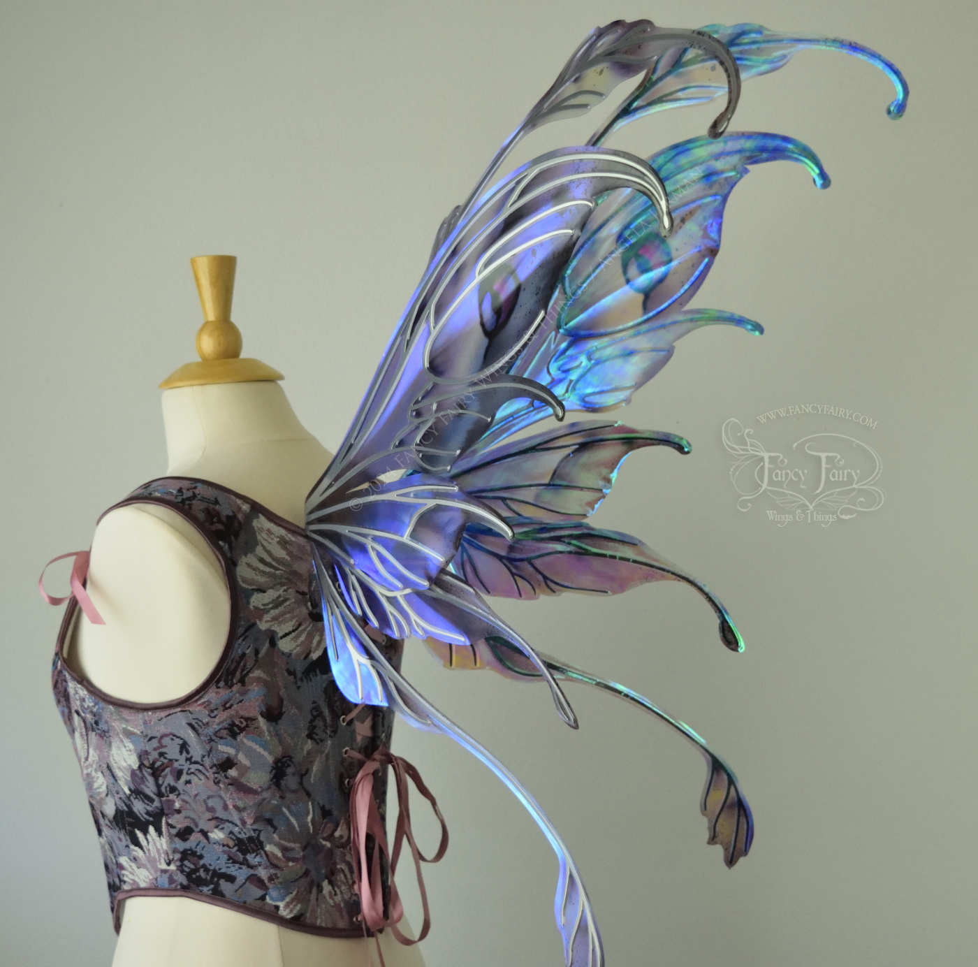 Iridescent fairy wings with antennae in purples, blues, and black with red accent and silver veins, 3/4 back view