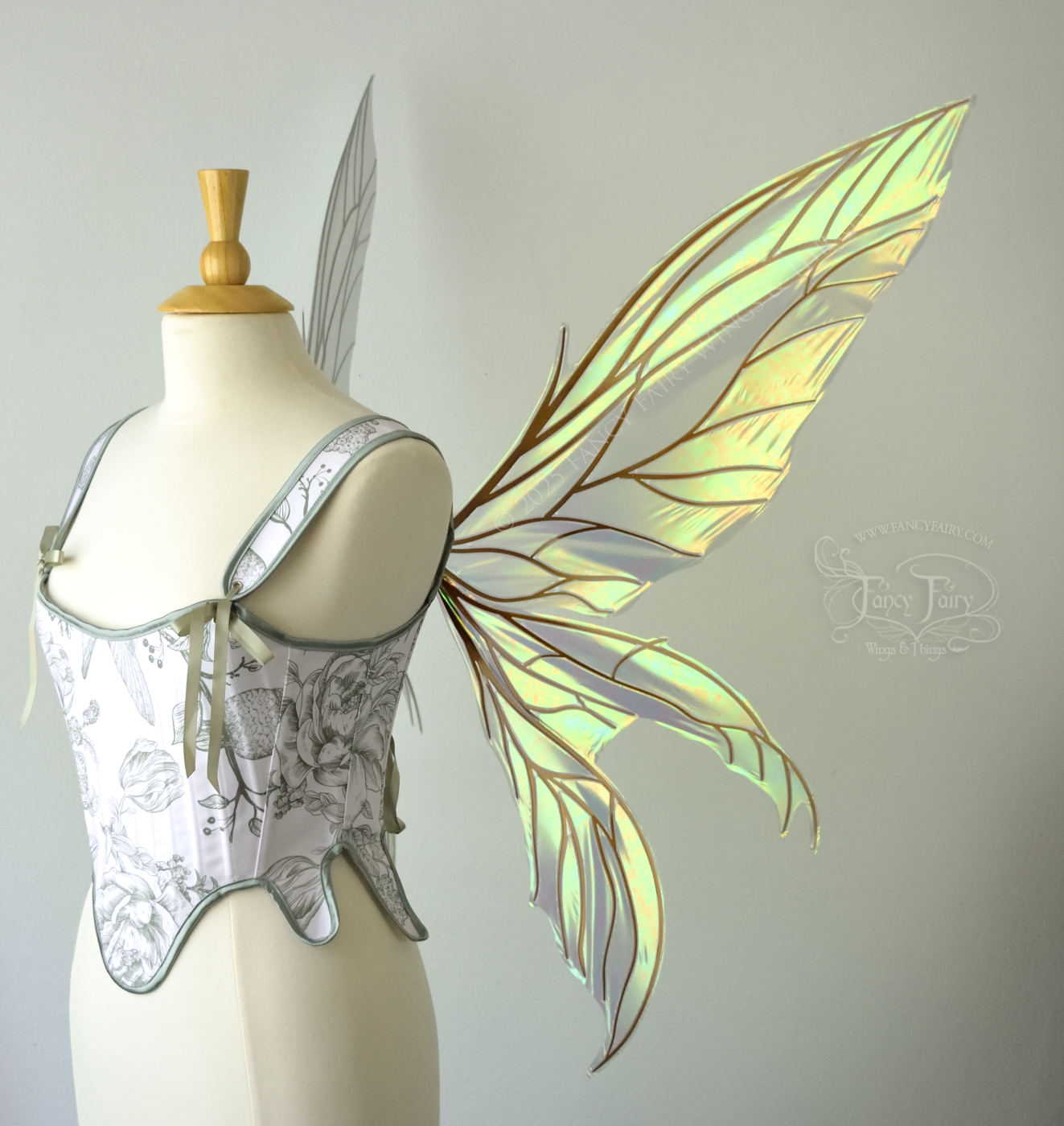 Large transparent iridescent orange/yellow/green dragonfly-like iridescent fairy wings with copper veins have 3 elongated panels on each side, worn on a dress form, right side view