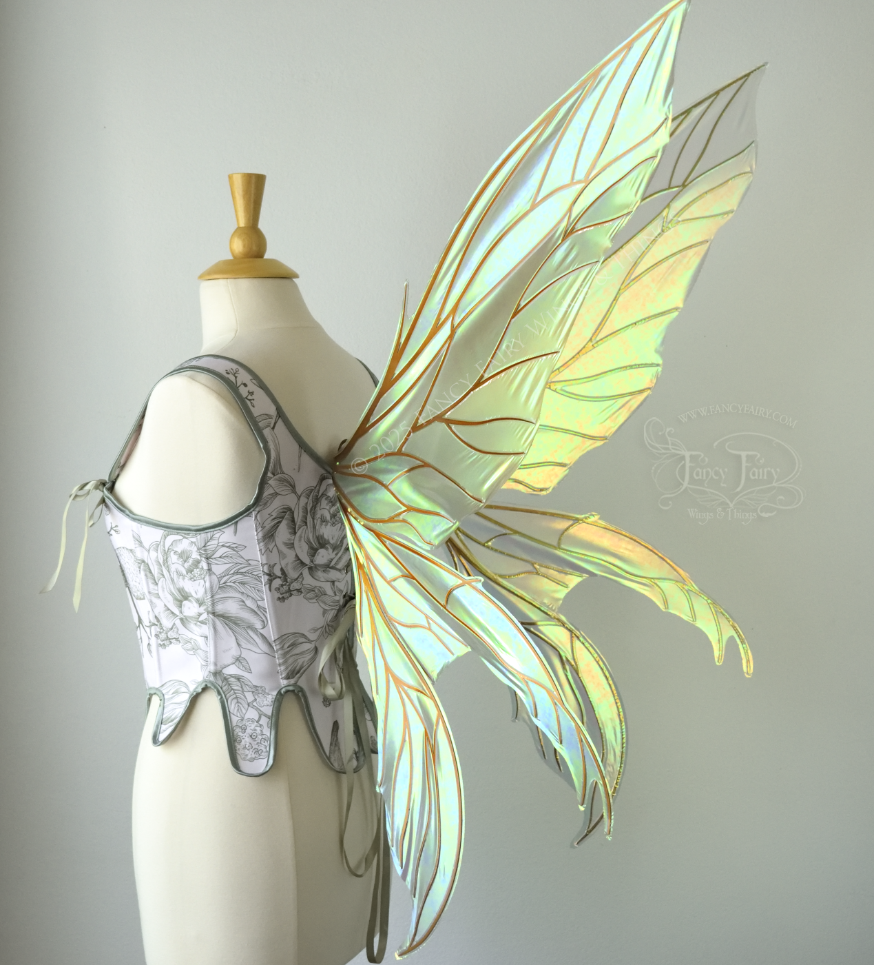 Large transparent iridescent orange/yellow/green dragonfly-like iridescent fairy wings with copper veins have 3 elongated panels on each side, worn on a dress form, 3/4 back view