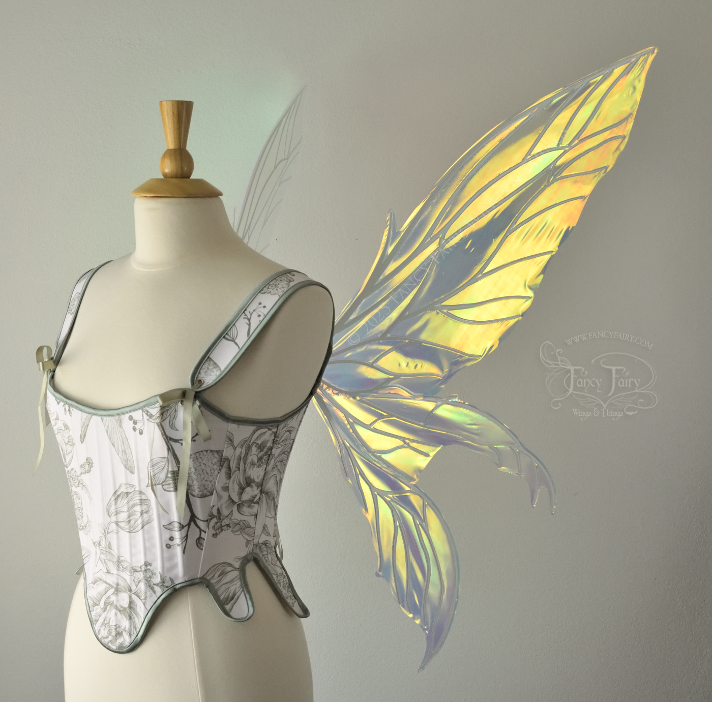 Large transparent yellow/orange/green iridescent fairy wings with white veins. Upper panels are elongated with pointed tips, 2 lower panels curve downward, worn on a dress form, right side view