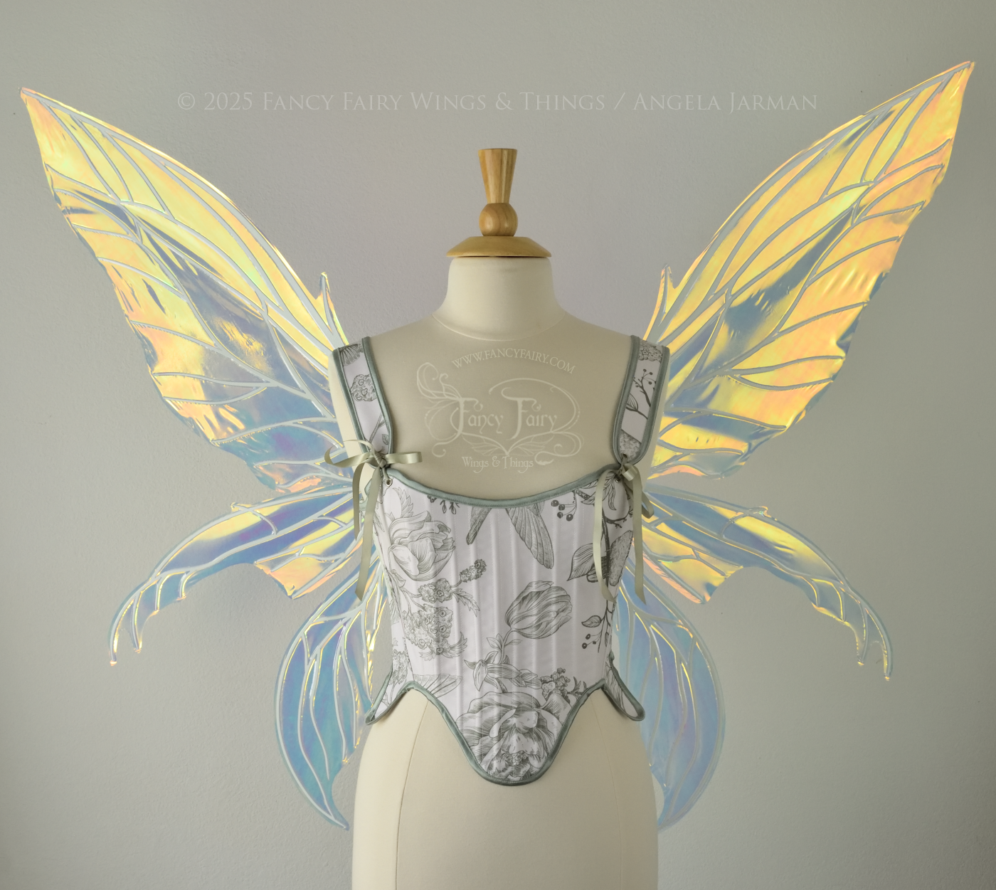Large transparent yellow/orange/green iridescent fairy wings with white veins. Upper panels are elongated with pointed tips, 2 lower panels curve downward, worn on a dress form, front view