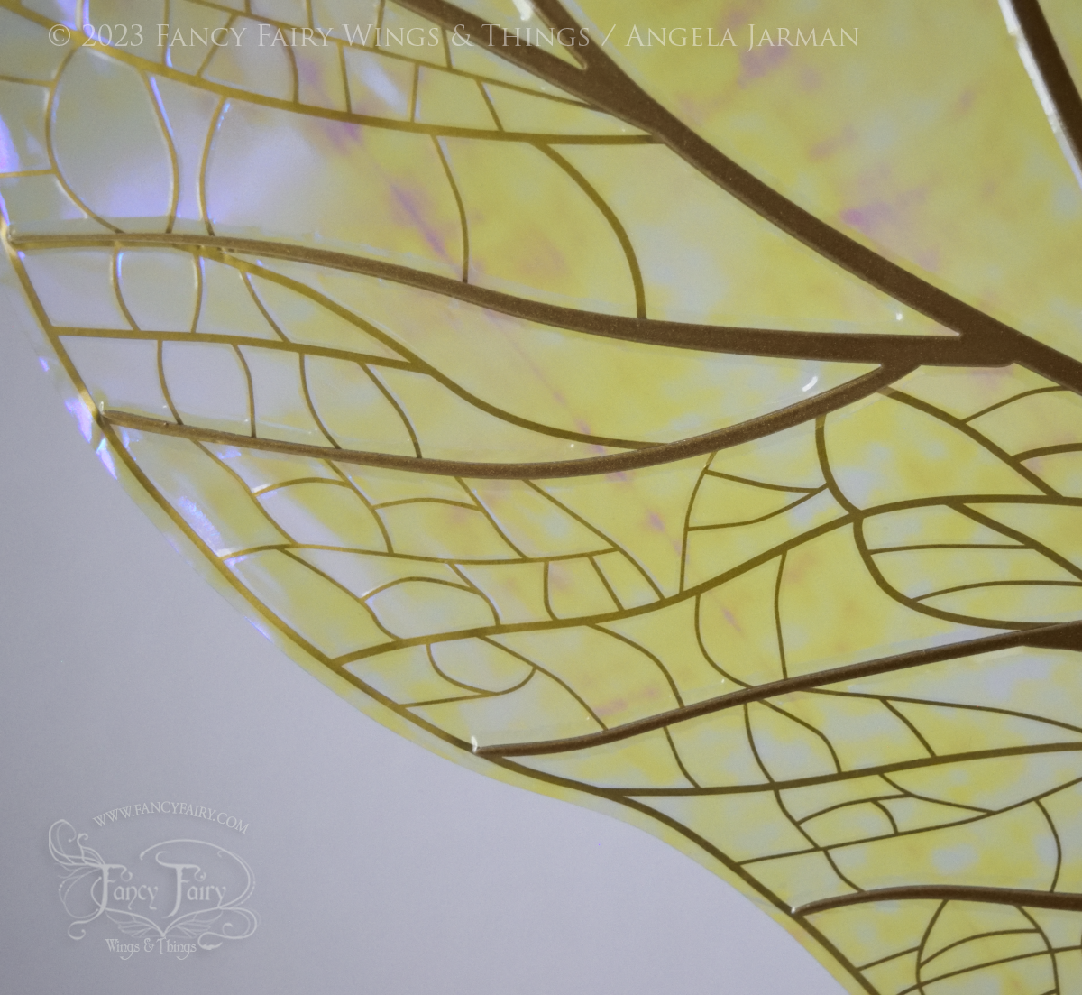 Closeup of detailed gold veins against white background