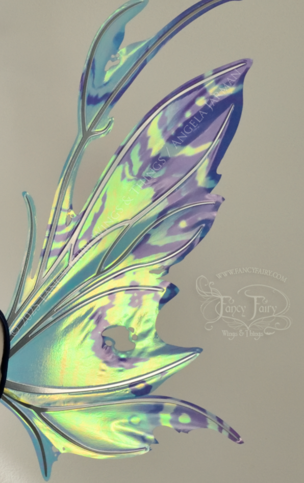Teal, blue and silver iridescent fairy wings with a spikey profile and antennae, right side view, worn on a dress form