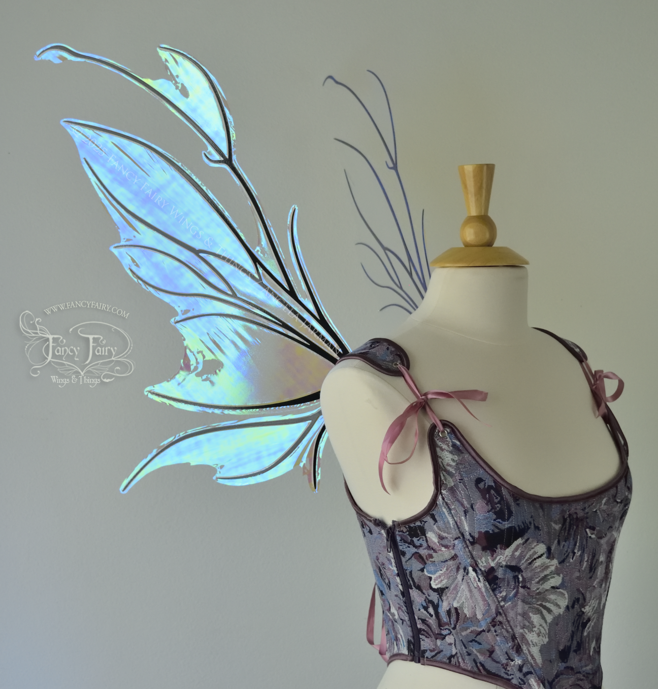 Iridescent & transparent blue fairy wings with black veins and antennae, worn on a dress form, left side view