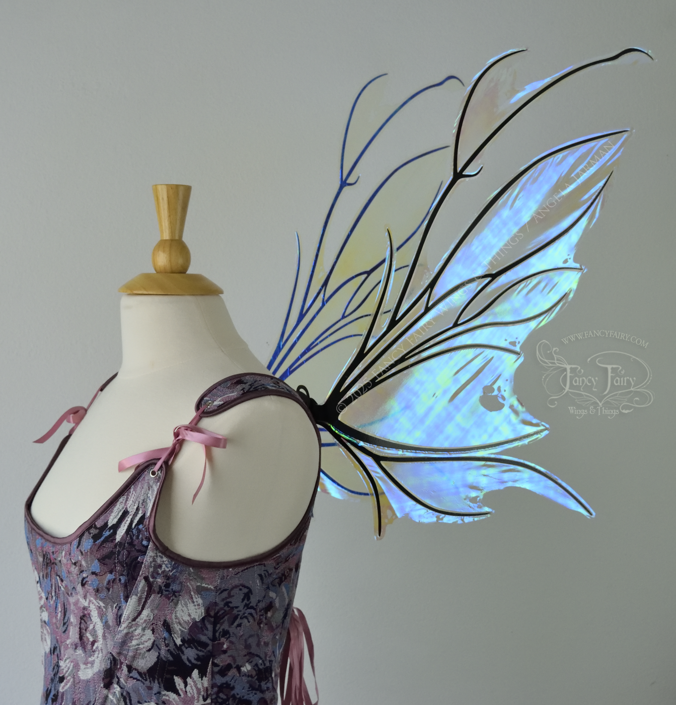 Iridescent & transparent blue fairy wings with black veins and antennae, worn on a dress form, right side view
