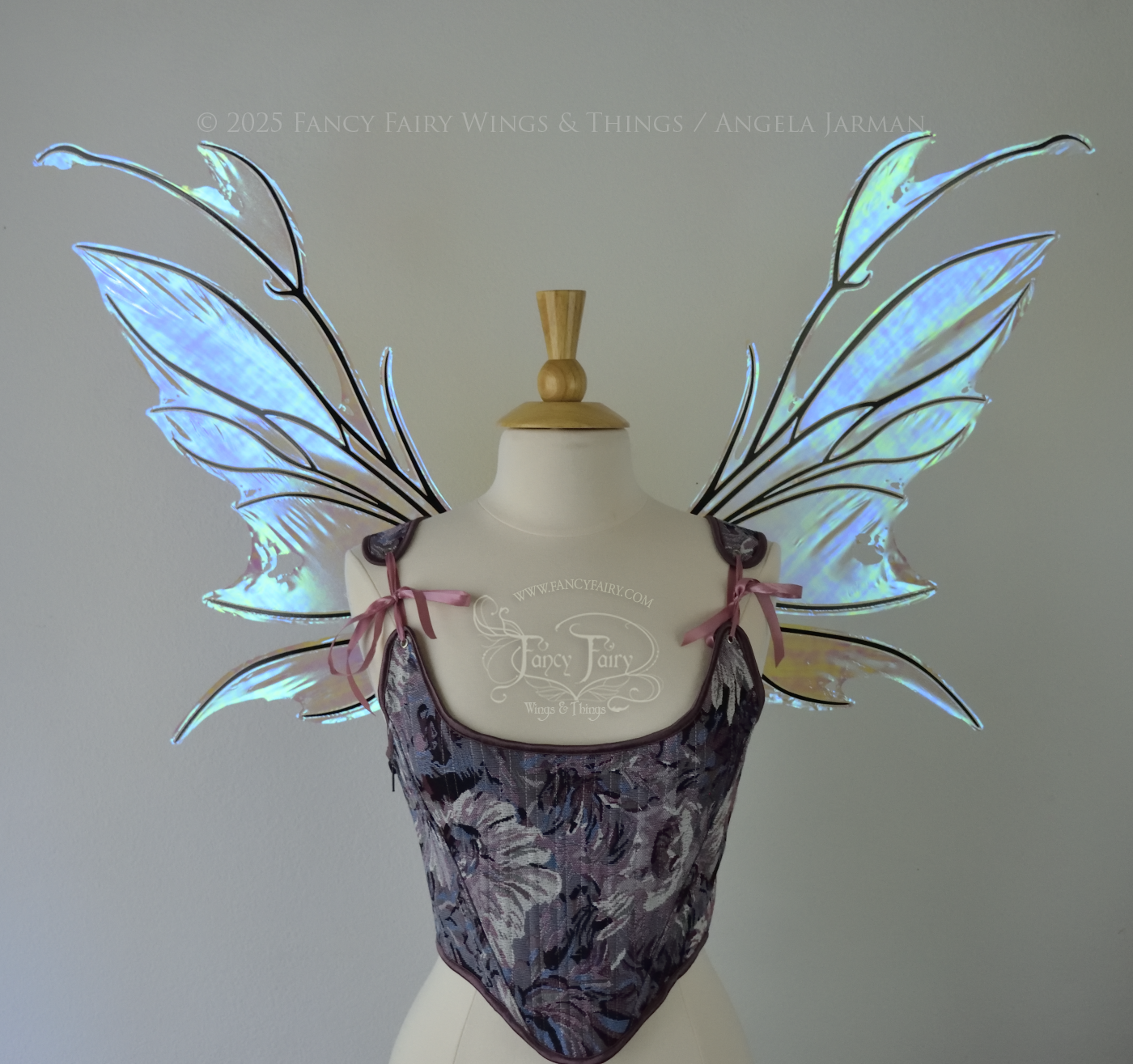 Iridescent & transparent blue fairy wings with black veins and antennae, worn on a dress form, front view