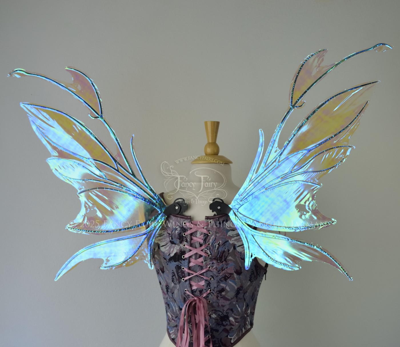 Iridescent & transparent blue fairy wings with black veins and antennae, worn on a dress form, back view