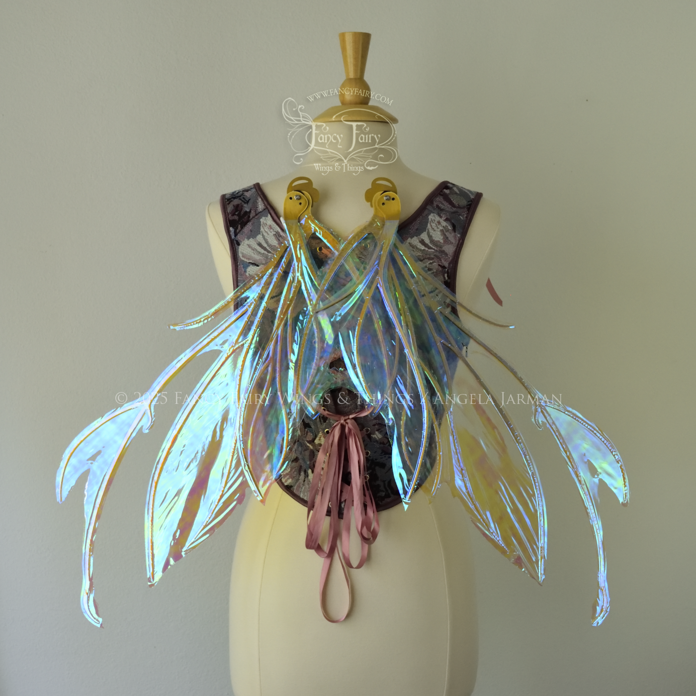 Transparent blue / green iridescent fairy wings with antennae and tattered holes with gold veins, worn on a dress form, back view, in resting position