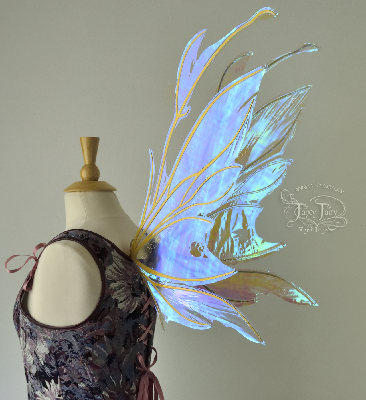 Transparent blue / green iridescent fairy wings with antennae and tattered holes with gold veins, worn on a dress form, back 3/4 view