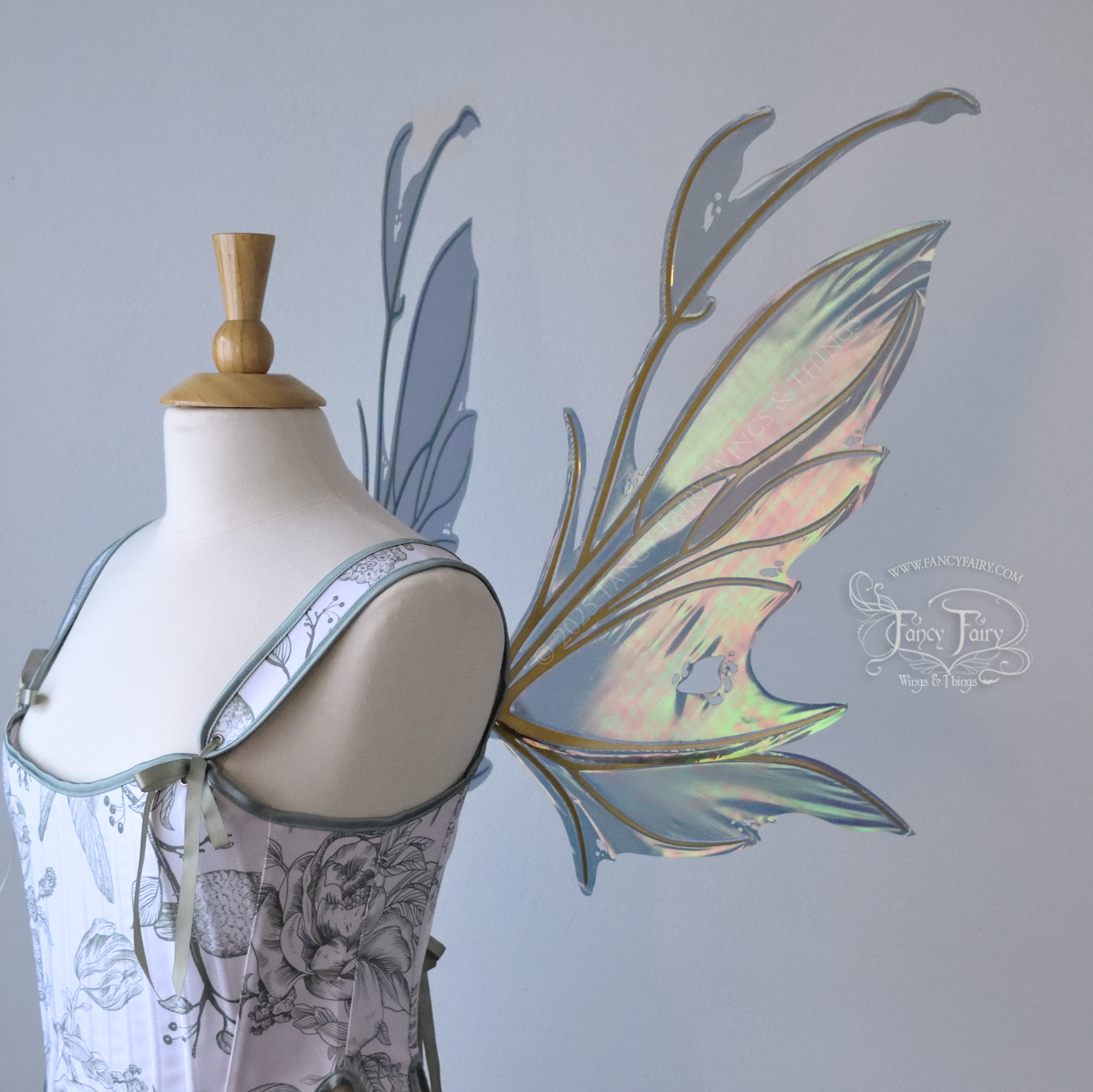 Dark orange / green & grey iridescent fairy wings with antennae and a spikey silhouette with tattered holes and gold veins, worn on a dress form, right side view