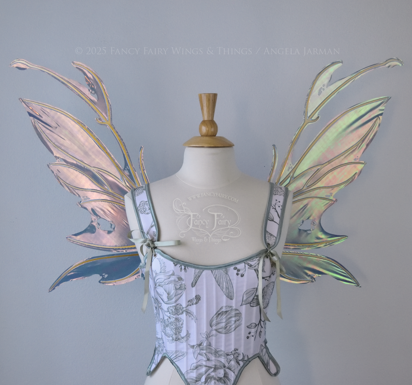 Dark orange / green & grey iridescent fairy wings with antennae and a spikey silhouette with tattered holes and gold veins, worn on a dress form, front view