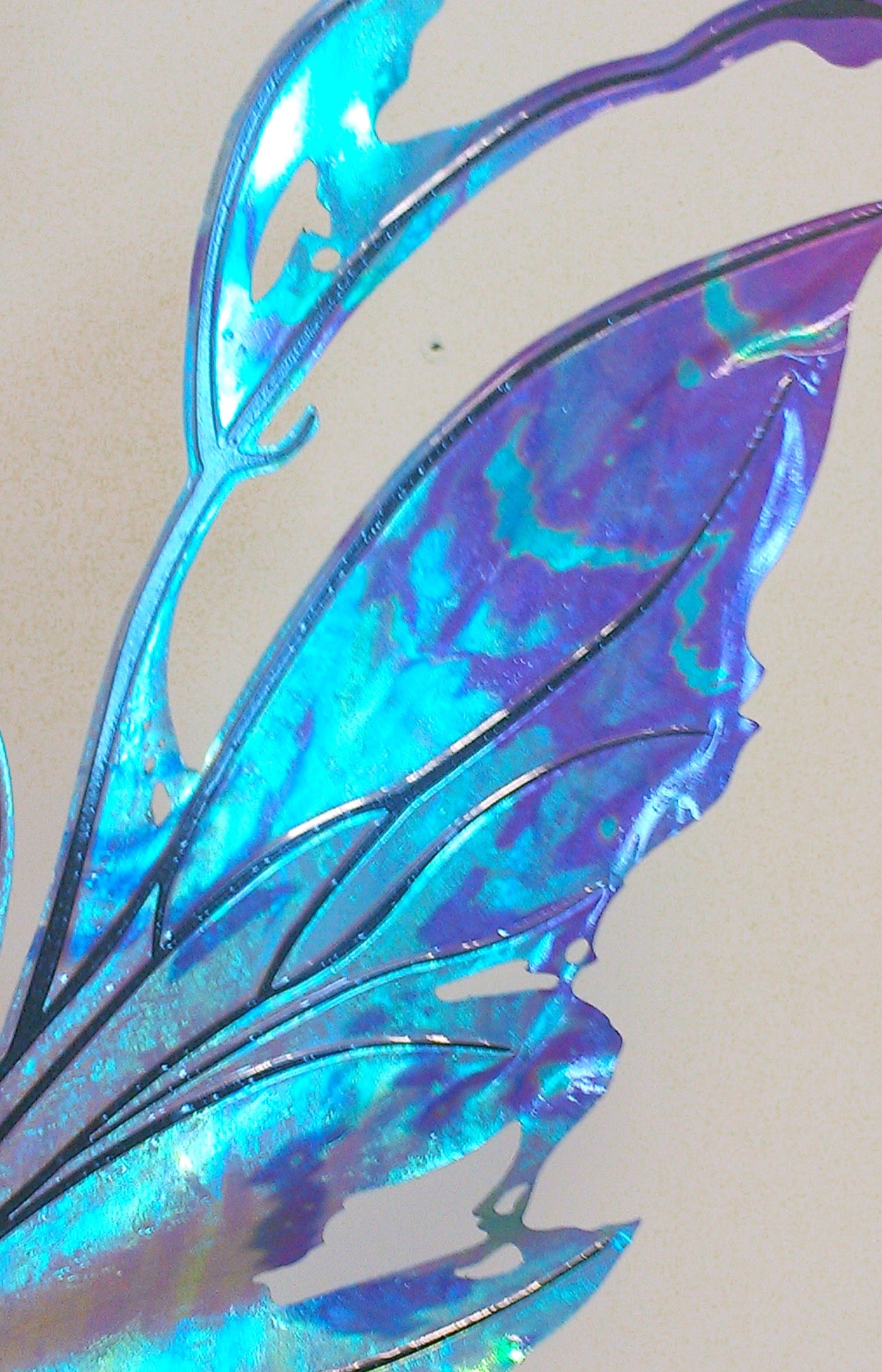Closeup of Kira wings in blues teals