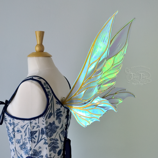 Iridescent blue / green fairy wings with elongated pointy upper panels and small leaf like lower panels, with gold veins, 3/4 back right side view
