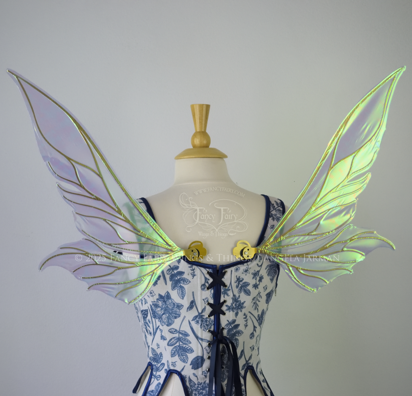 Iridescent blue / green fairy wings with elongated pointy upper panels and small leaf like lower panels, with gold veins, back view