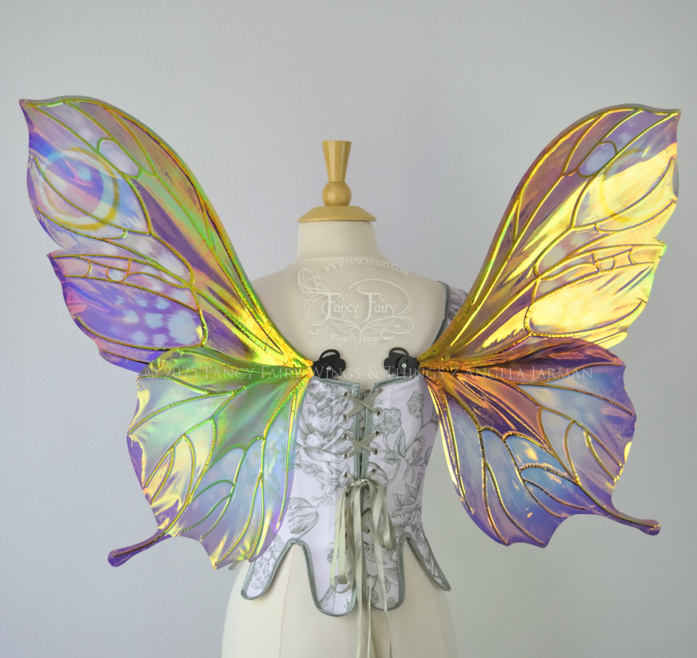 Iridescent fairy wings with a butterfly-like shape and short 'tails' in purples & blues with touches of pink & orange, back view