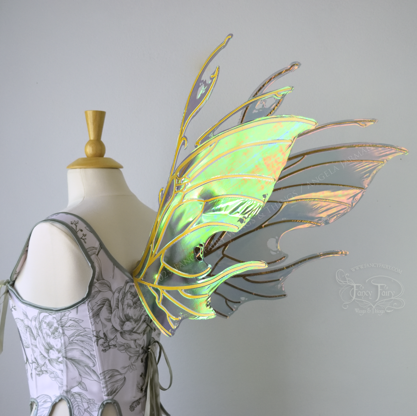 Beetle inspired iridescent orange, green & grey costume wings with antennae and gold veins, worn on a dress form, back 3/4 view