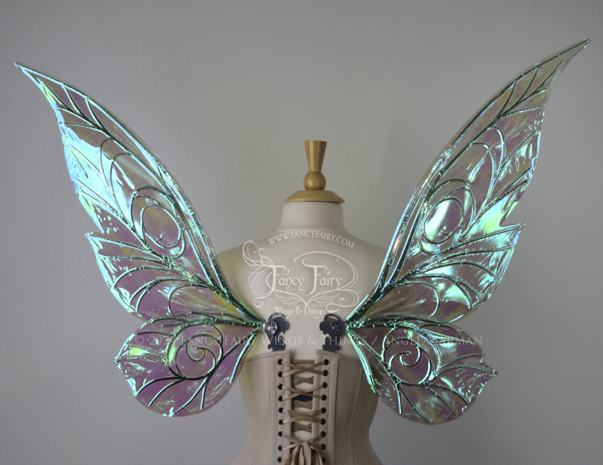 Back view of green iridescent Tinker Bell inspired fairy wings with swirly silver veins, displayed on a dress form
