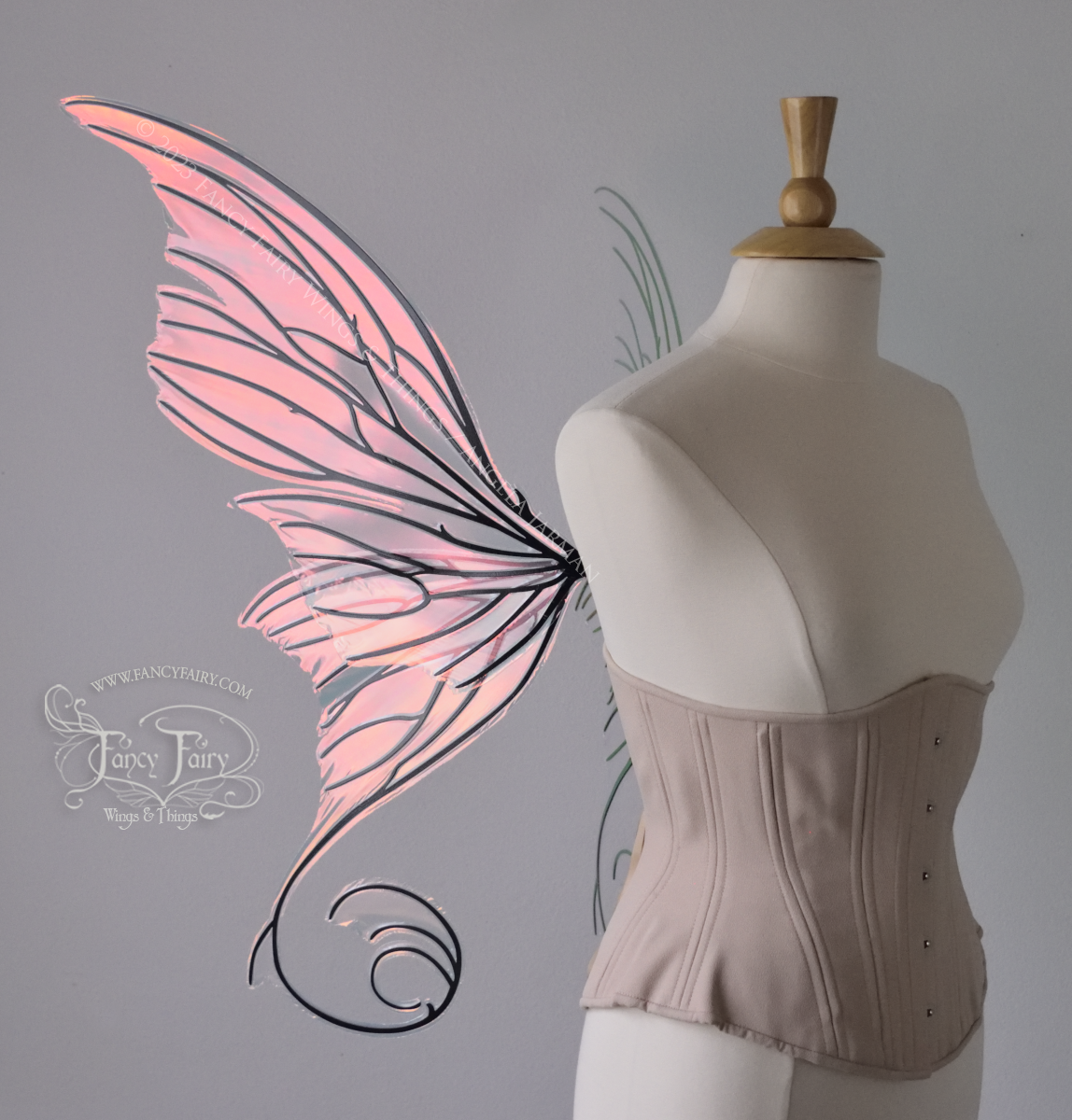 Left side view of an ivory dress form wearing an alabaster underbust corset and large pink / orange iridescent fairy wings with lots of intricate black veins, some have 'thorns'. Upper panels curve slightly downwards along top edge with pointy tips, bottom panels have tails