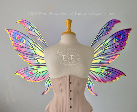 iridescent rainbow fairy wings with black veins, worn on a dress form, front view