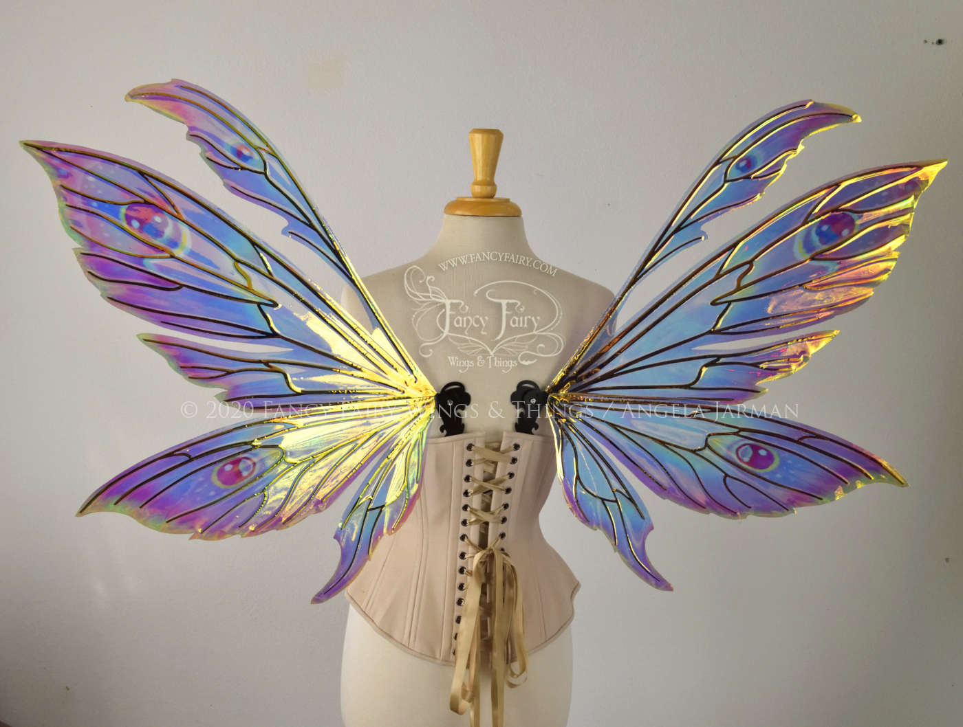 iridescent rainbow fairy wings with black veins, worn on a dress form, back view
