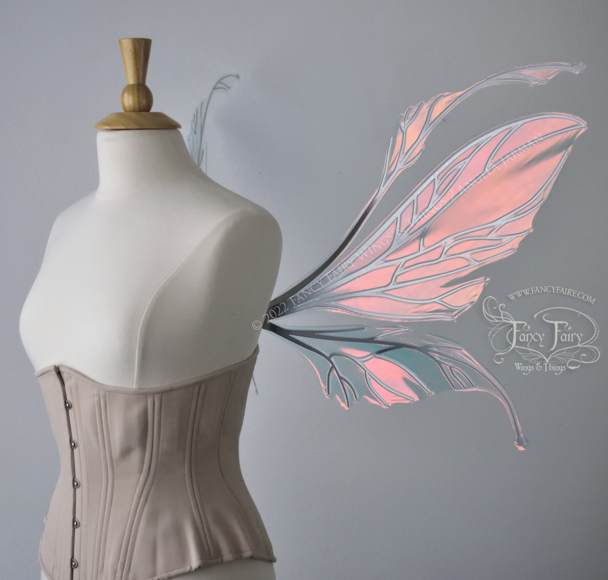 Large pink / orange iridescent fairy wings with antennae along the top, with silver veins, worn on a dressform, right side view