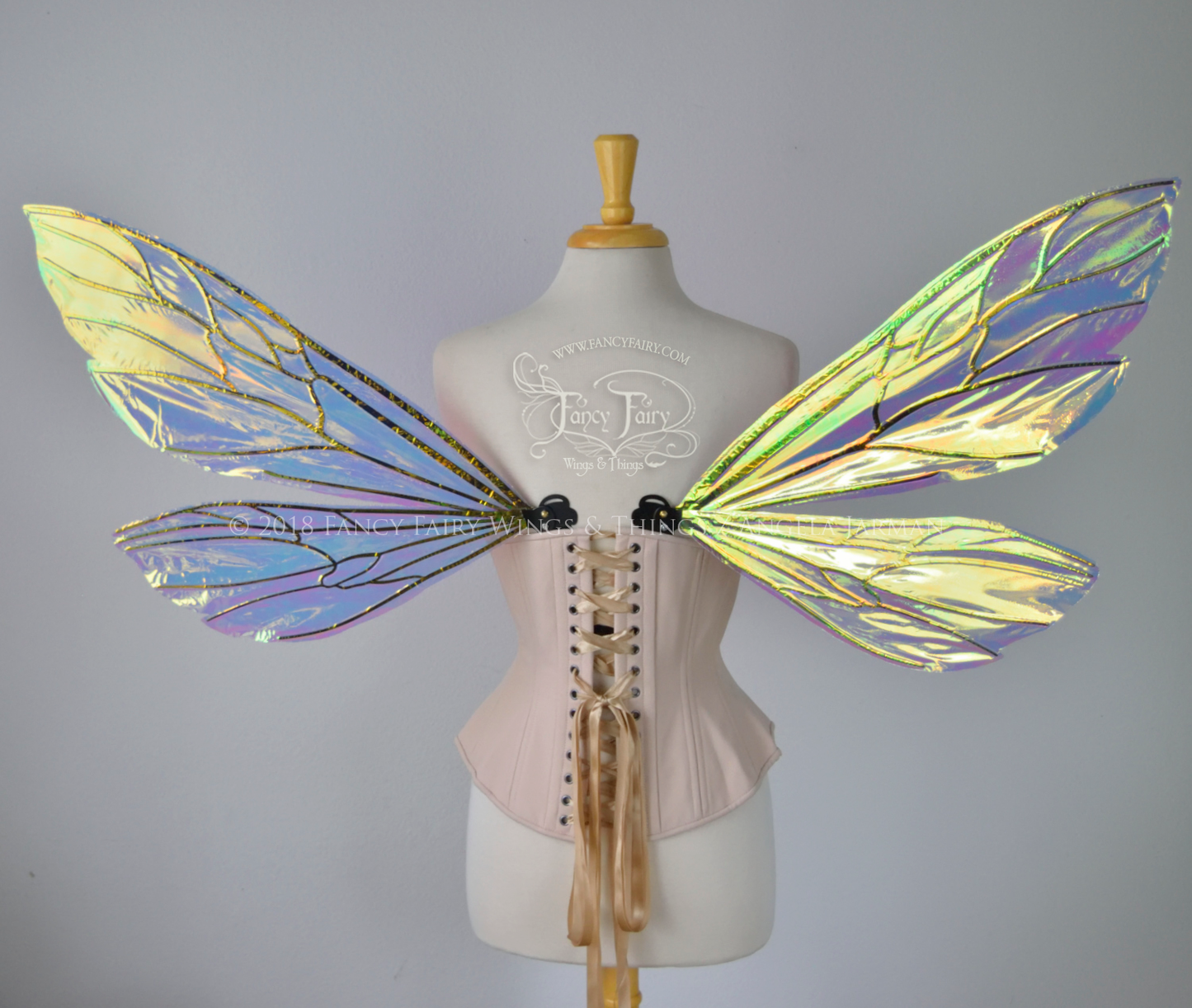 Transparent iridescent wasp-like fairy wings with black veins worn on a dress form, back view