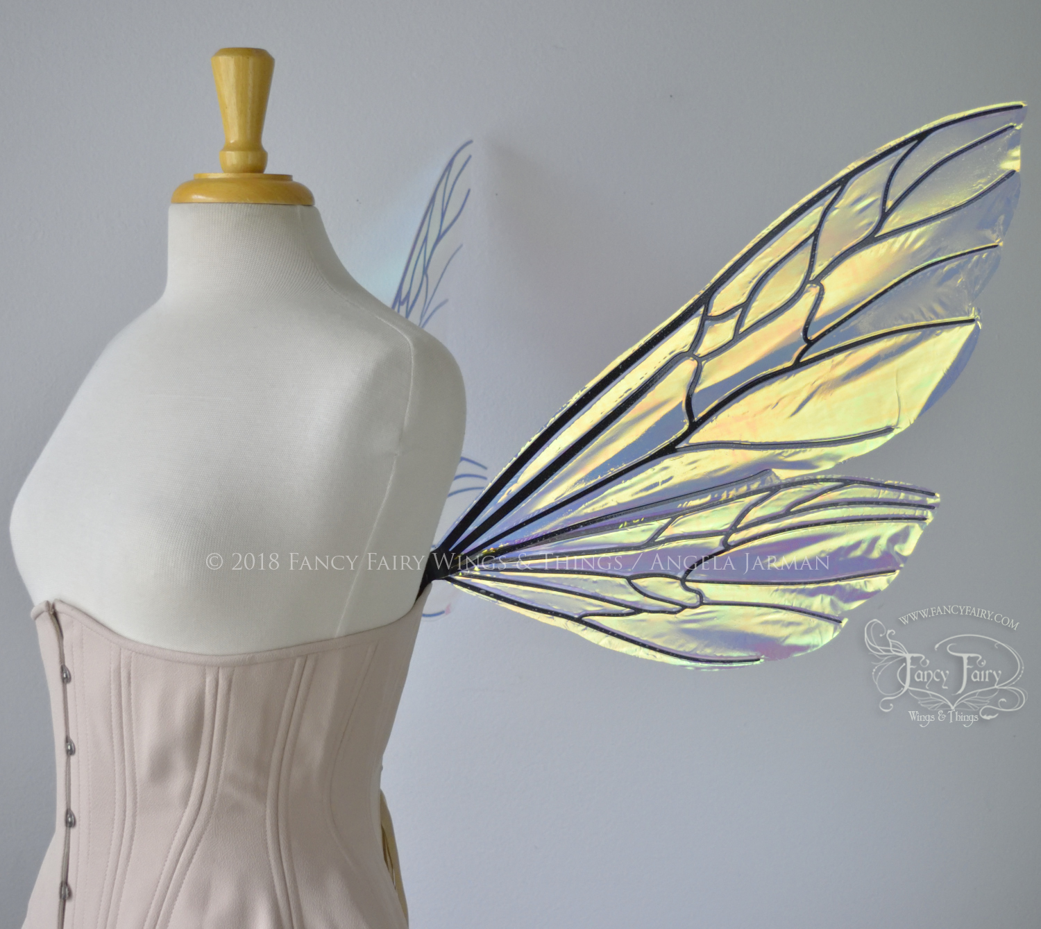 Transparent iridescent wasp-like fairy wings with black veins worn on a dress form, right side view