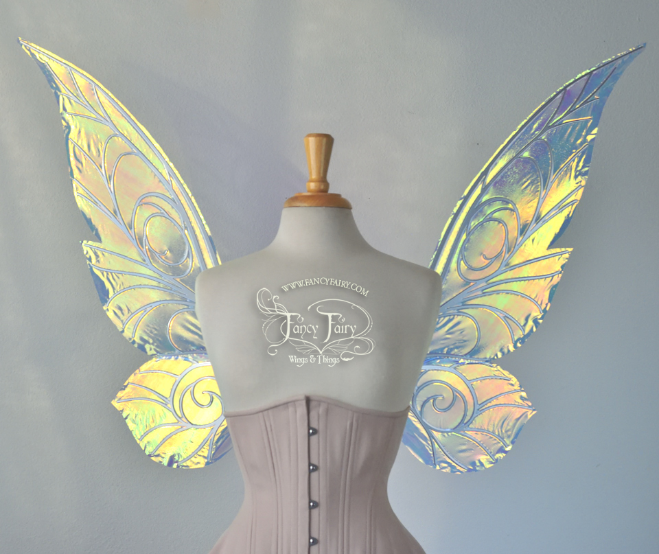 Front view of transparent green/yellow/orange iridescent Tinker Bell inspired fairy wings with swirly white veins, displayed on a dress form