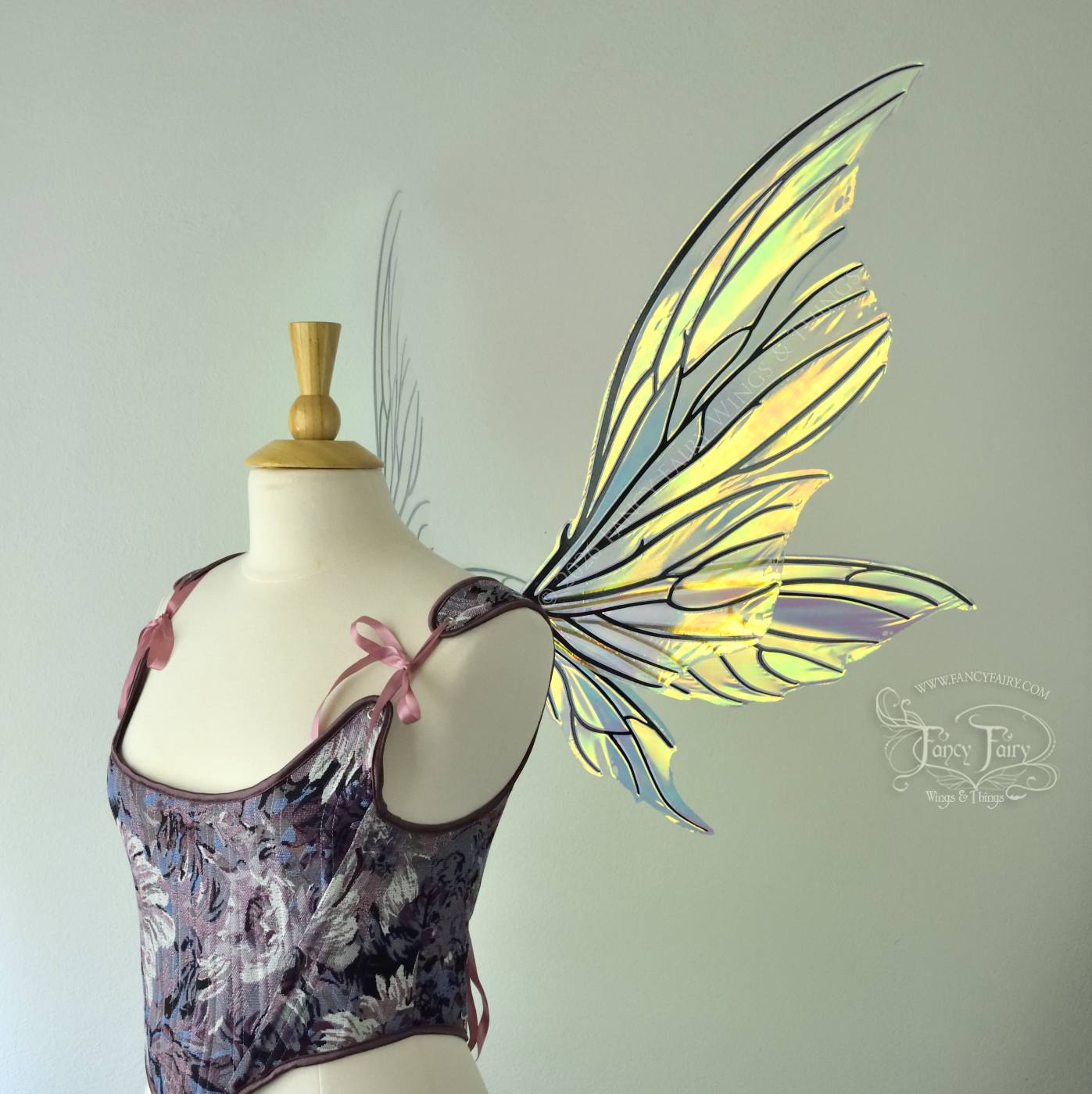 Iridescent yellow/orange/green transparent fairy wings with lots of 'thorny' black veins, worn on a dress form, right side view