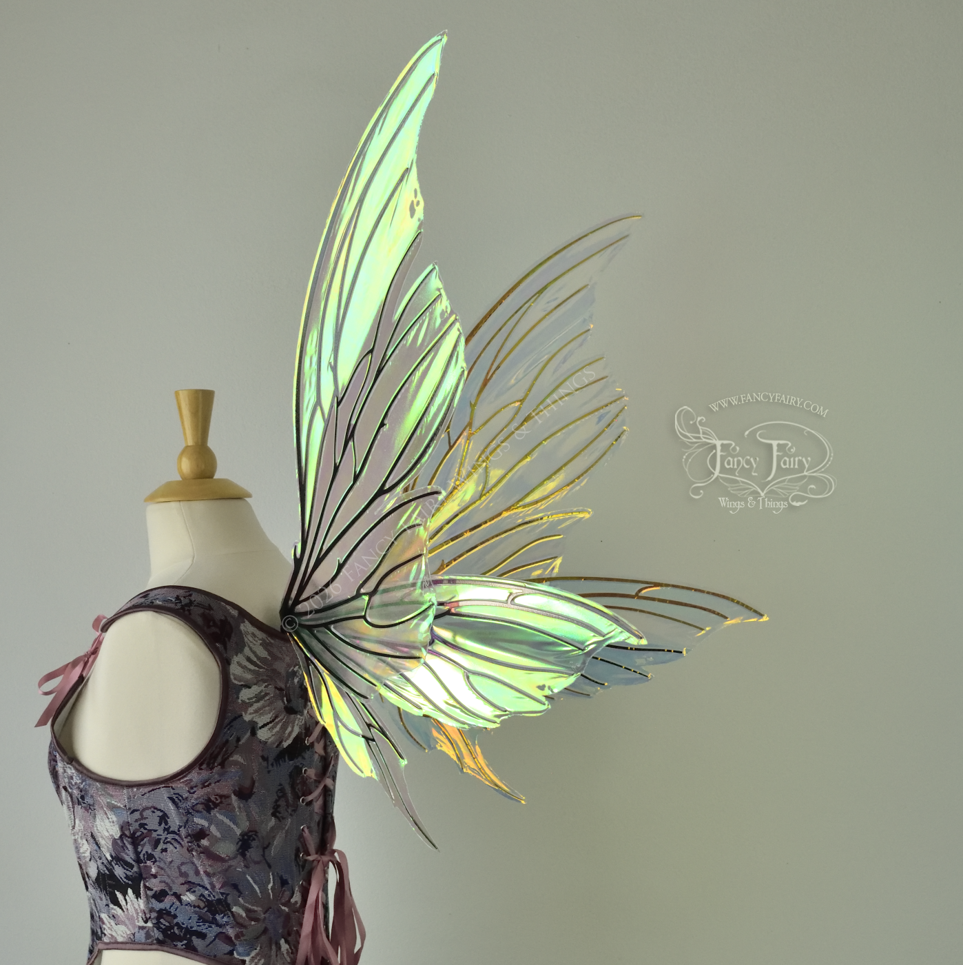 Iridescent yellow/orange/green transparent fairy wings with lots of 'thorny' black veins, worn on a dress form, back 3/4 view