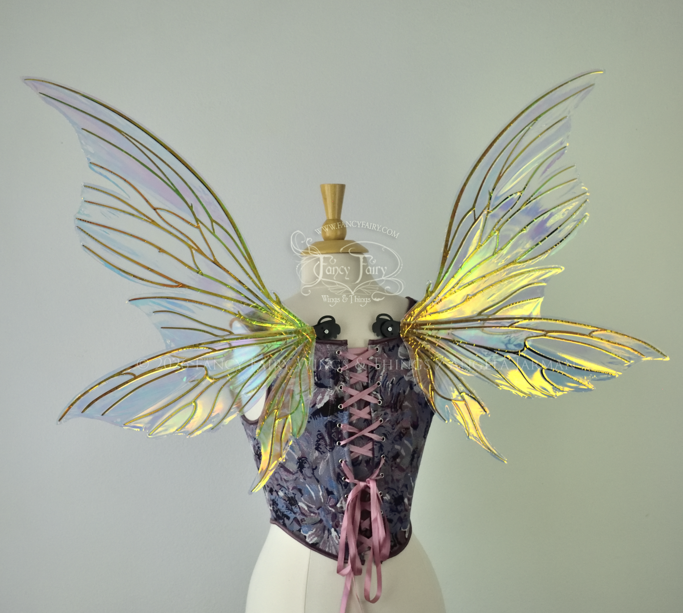 Iridescent yellow/orange/green transparent fairy wings with lots of 'thorny' black veins, worn on a dress form, back view