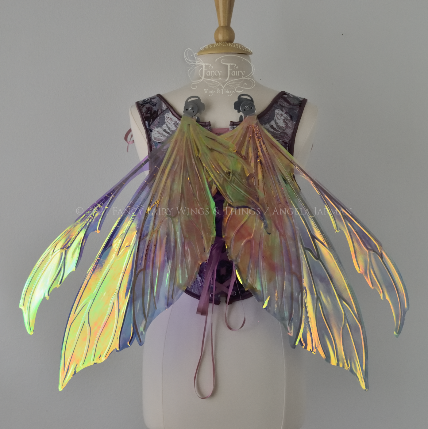 Iridescent fairy wings with pointed tips & antennae, painted with auroras & stars in pinks, purples & blues, with silver veins, back view in resting position