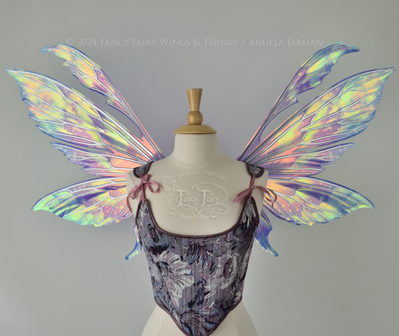 Iridescent fairy wings with pointed tips & antennae, painted with auroras & stars in pinks, purples & blues, with silver veins, front view