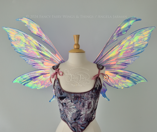 Iridescent fairy wings with pointed tips & antennae, painted with auroras & stars in pinks, purples & blues, with silver veins, front view