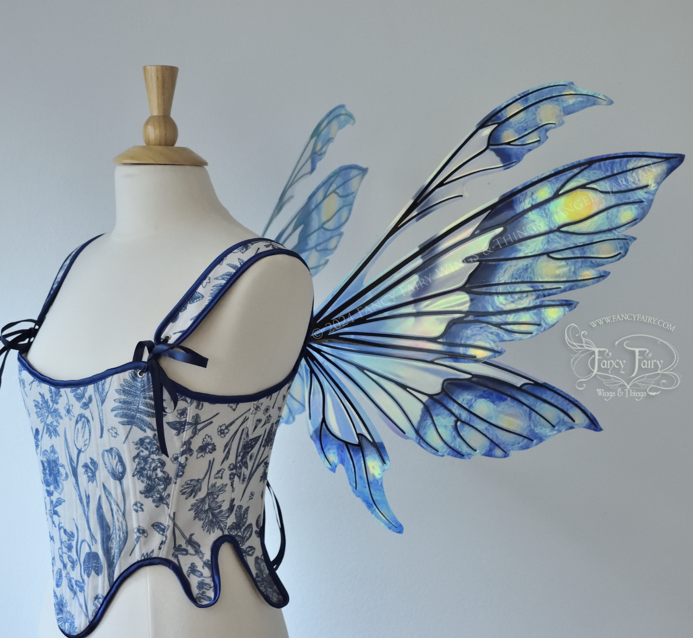 Iridescent fairy wings painted like Van Gogh's Starry Night, worn on a dress form, right side view