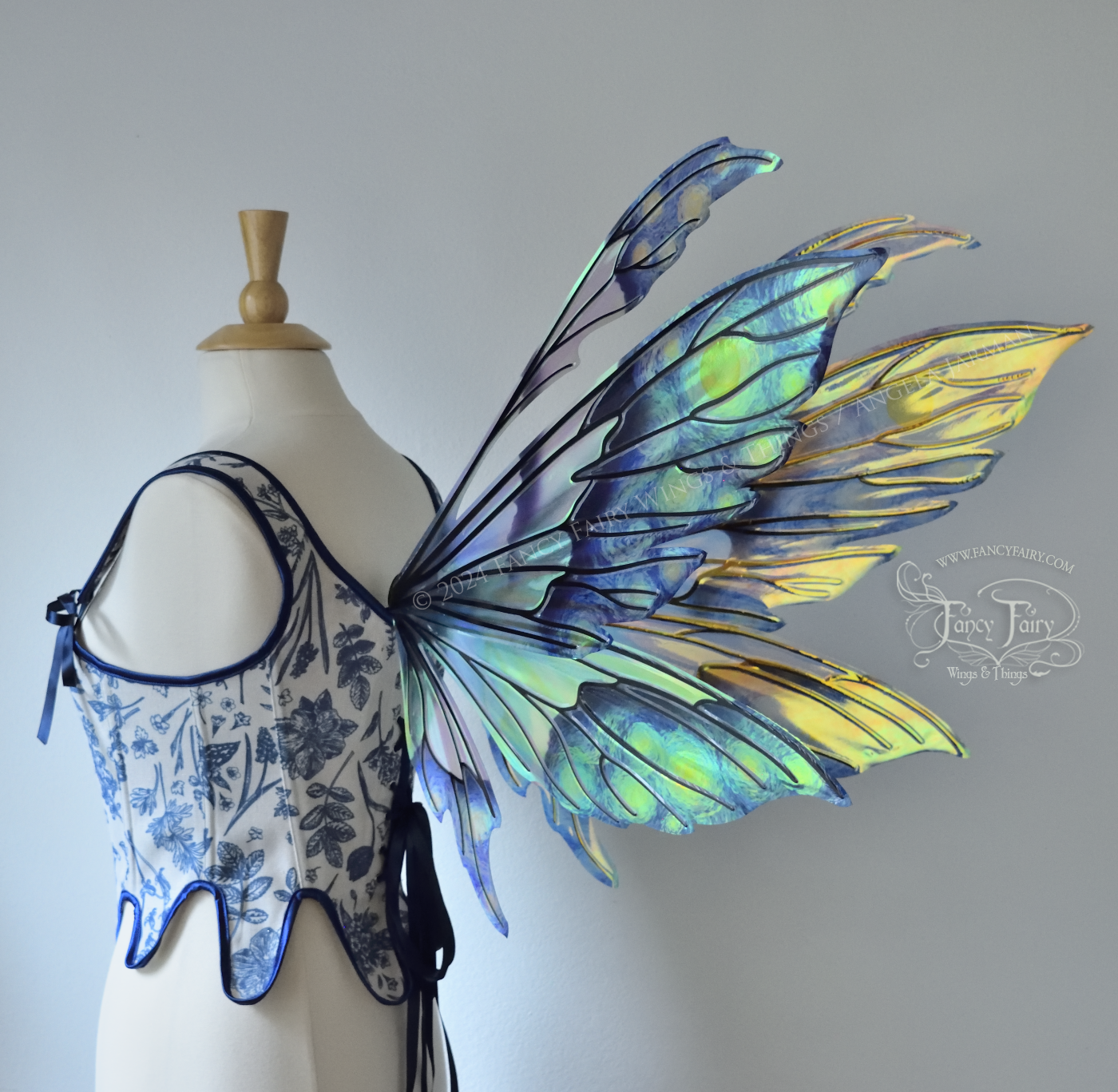 Iridescent fairy wings painted like Van Gogh's Starry Night, worn on a dress form, back 3/4 view