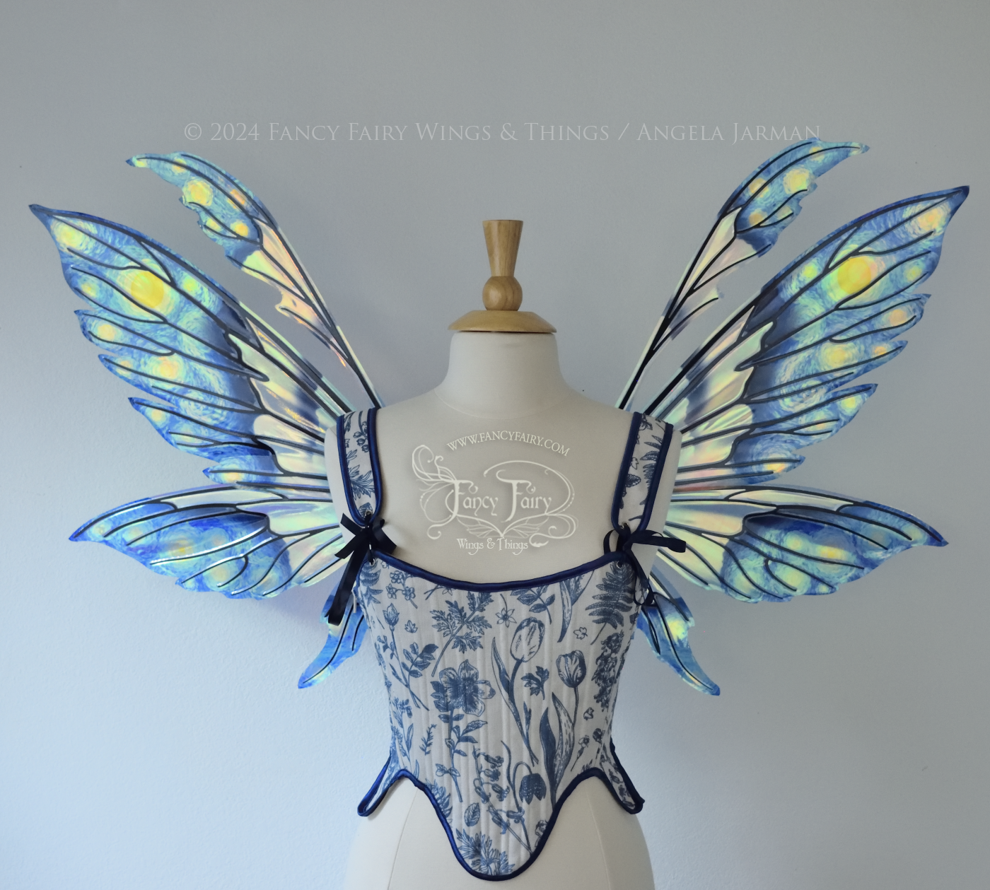 Iridescent fairy wings painted like Van Gogh's Starry Night, worn on a dress form, front view