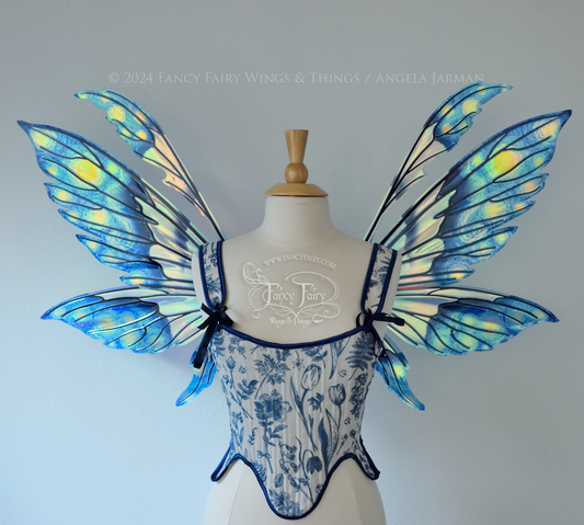 Iridescent fairy wings painted like Van Gogh's Starry Night, worn on a dress form, front view