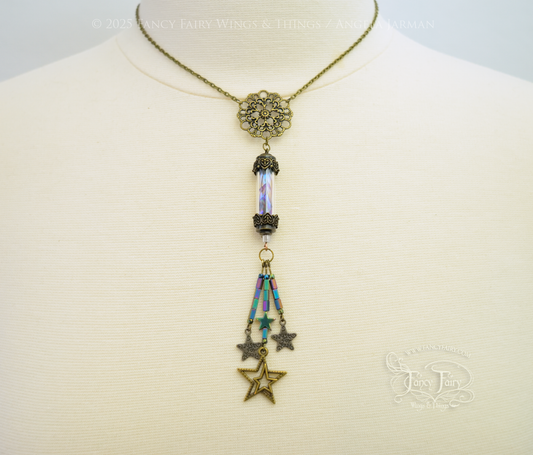 Bronze necklace with vial containing fairy wings & star charms dangling from the bottom