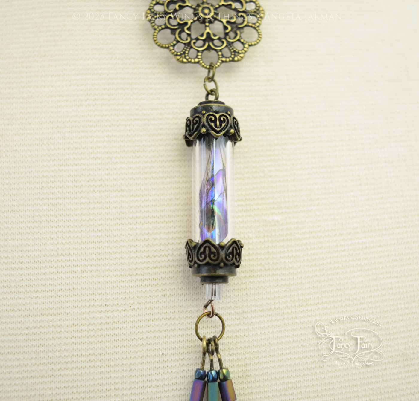 Closeup of bronze necklace with vial containing fairy wings