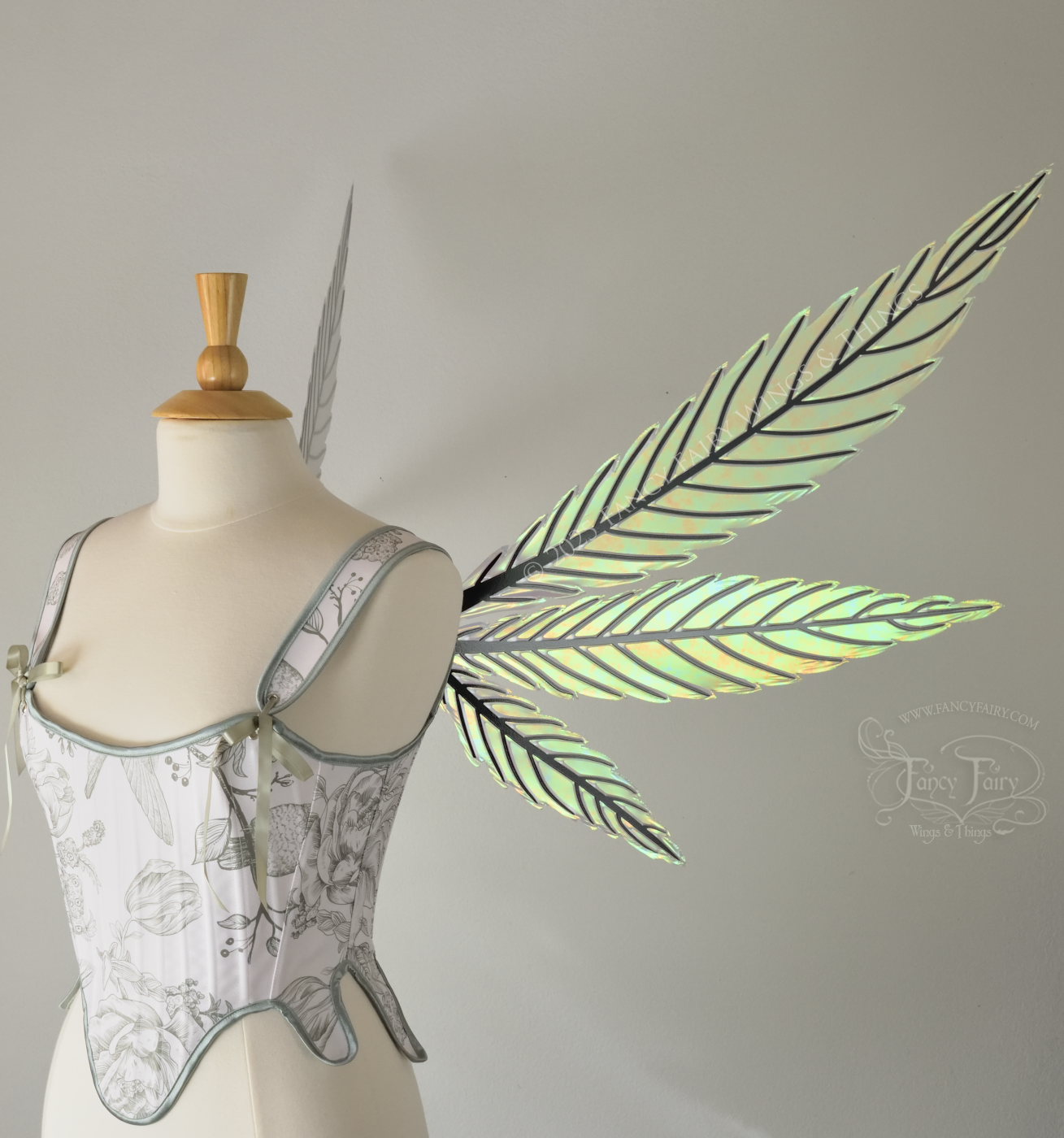 Green iridescent fairy wings styled after hemp leaves with black veins, worn on a dress form, right side view
